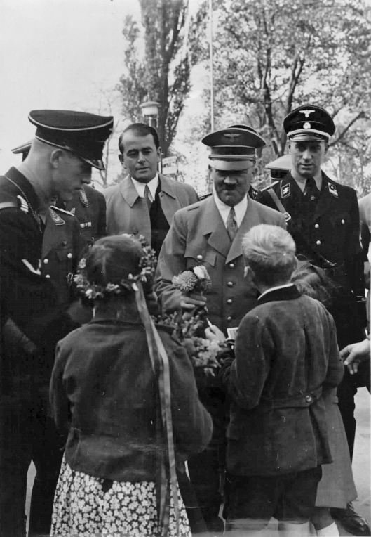 Adolf Hitler is welcomed by children before the exhibition 'Schaffendes Volk' in Düsseldorf